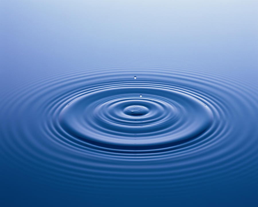 Water droplet falling on surface of water Photograph by Mixa