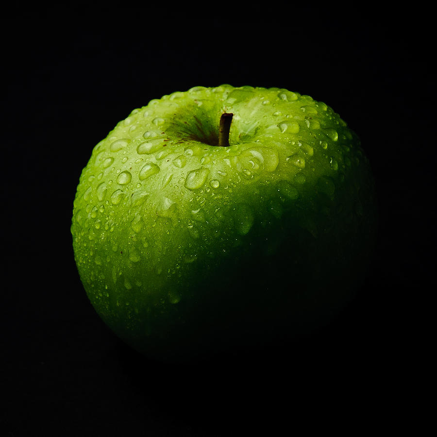 Water drops on green apple Photograph by Chris Scuffins