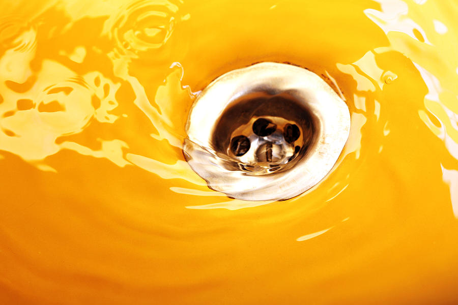 Water flowing down the orange drain Photograph by Deepblue4you