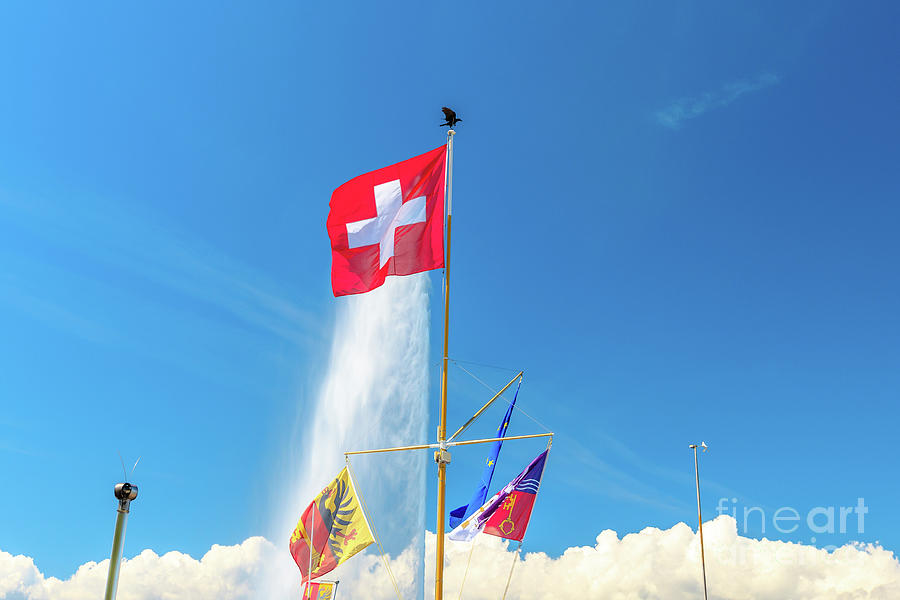 Water jet fountain and Swiss flag Photograph by Benny Marty
