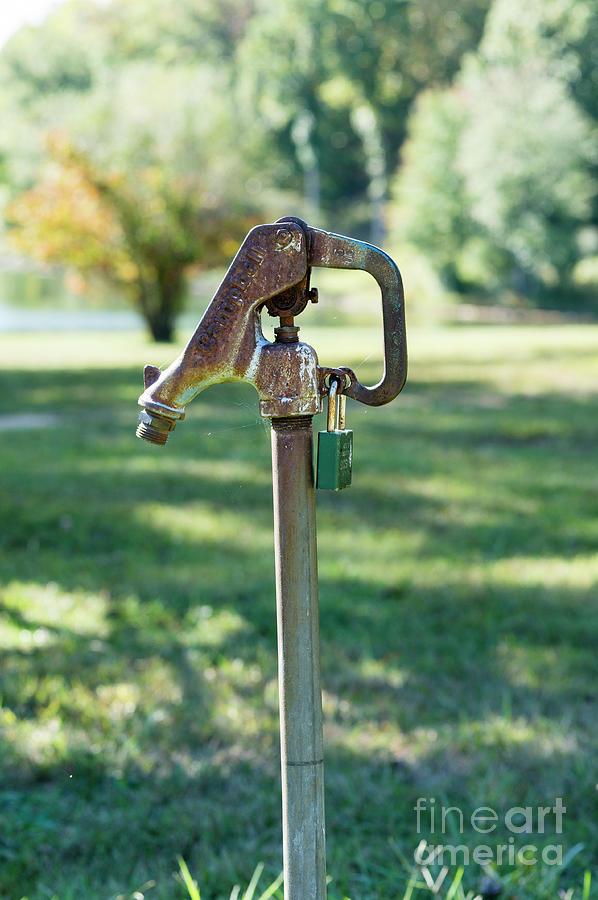 Water pump locked with a padlock Photograph by William Kuta