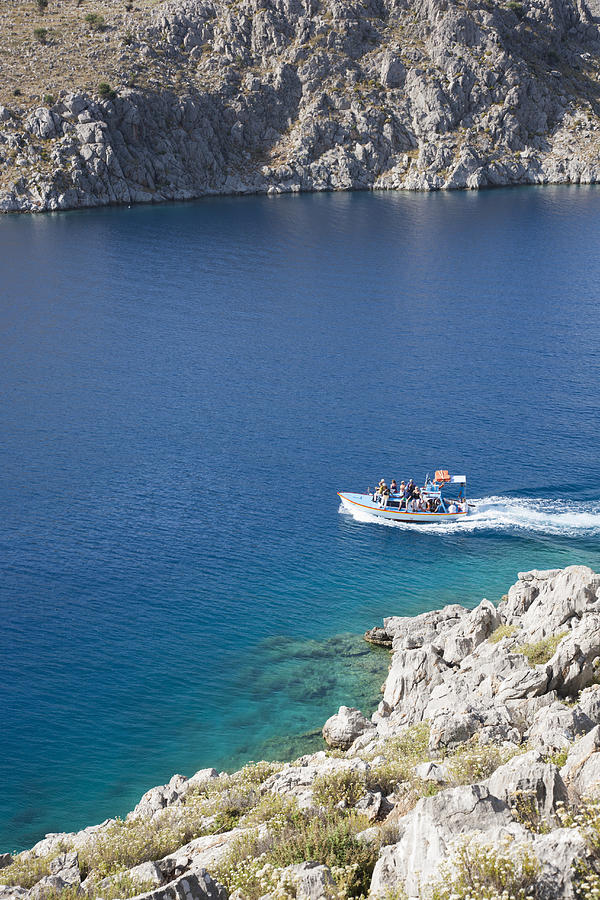 Water taxi crossing Pedi Bay, Pedi, Symi, Greece Photograph by David C Tomlinson