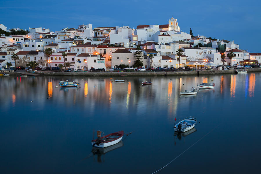 Water view of illuminated cityscape of Ferragudo in Algarve Photograph by LucynaKoch