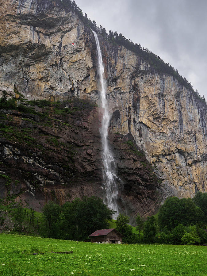 Waterfall and Swiss Flag in Lauterbrunnen Valley, Bernese Oberland, Switzerland Photograph by Pak Hong