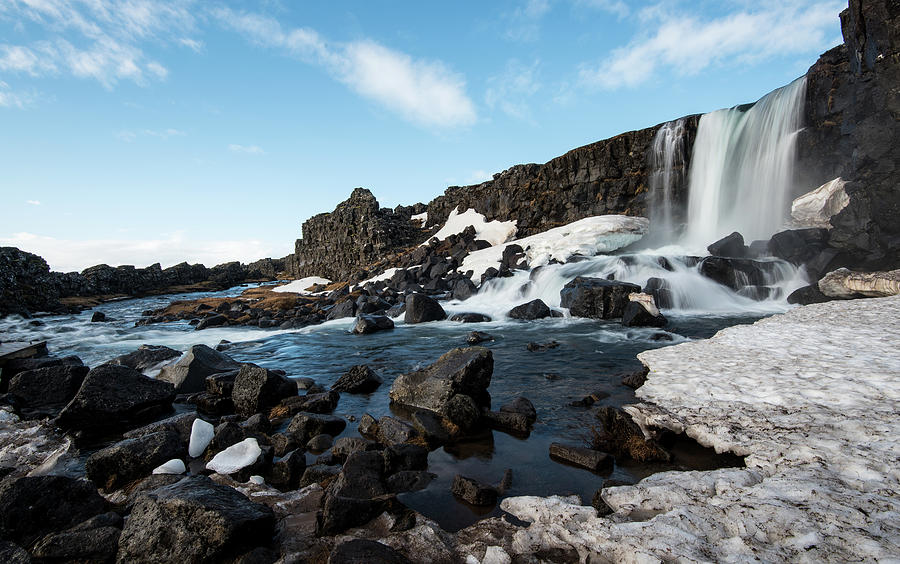 Waterfall flowing into the river, Iceland Photograph by Michalakis Ppalis