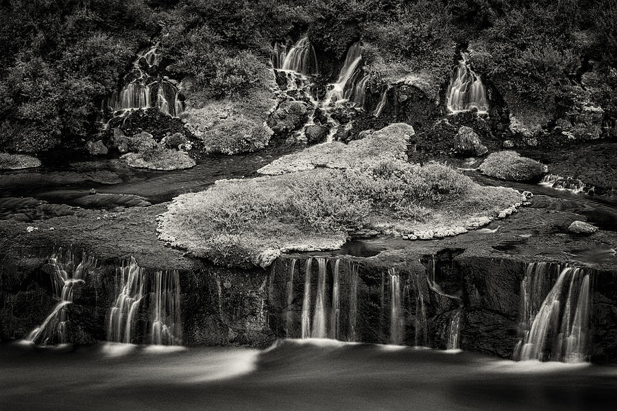 Waterfall flowing over rock formations to lake Photograph by Jeremy Woodhouse
