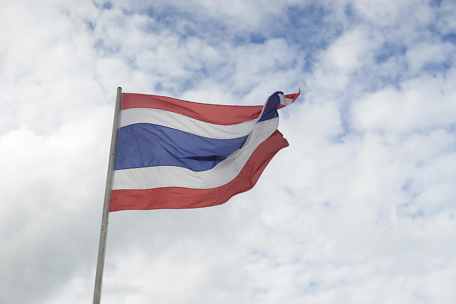 waving Thai flag of Thailand with blue sky background. Photograph by IttoIlmatar