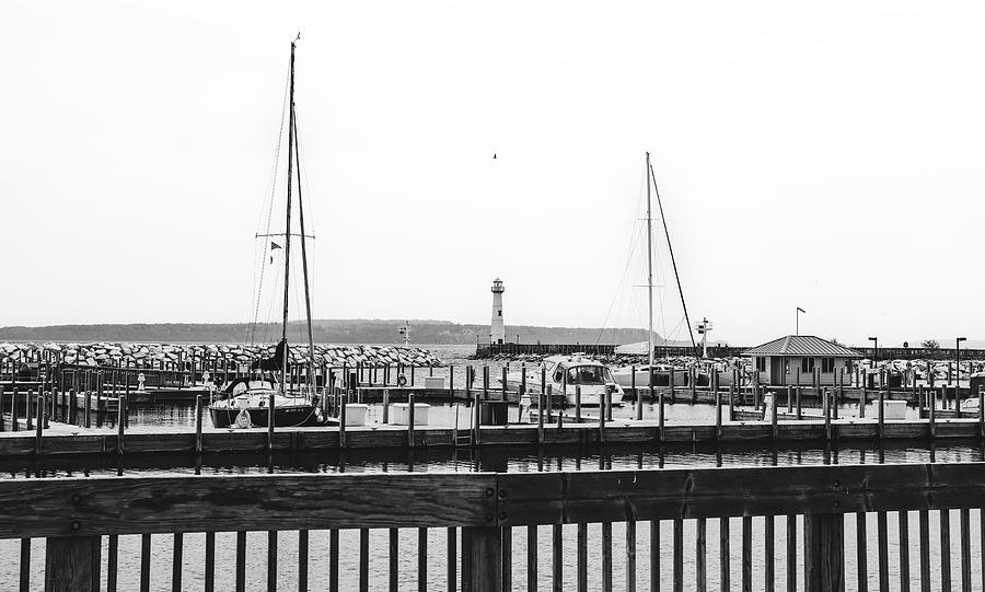 Lake Michigan Photograph - Wawatam Lighthouse Boats And Pier Black And White by Dan Sproul