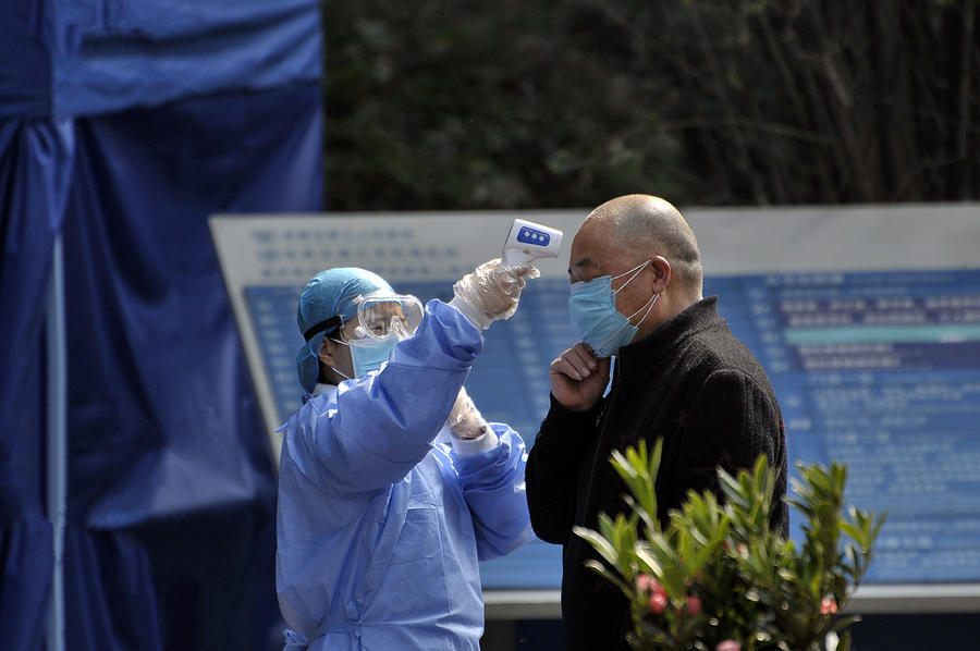 Wearing masks, people lined up for temperature checks before entering hospital in Chengdu,China Photograph by Caoyu36
