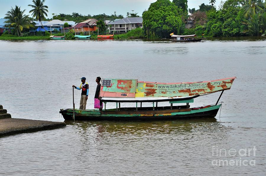 Nature Photograph - Weathered boat with sailor passenger and solar panel crosses Sarawak River Kuching Malaysia by Imran Ahmed