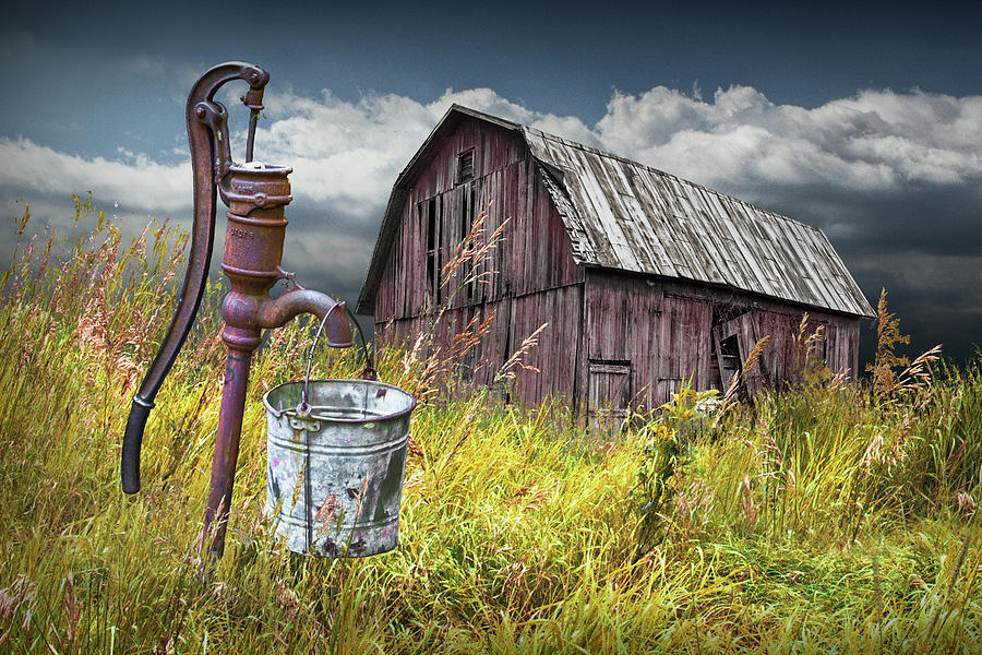 Weathered Wooden Barn with Water Pump and Metal Bucket Photograph by Randall Nyhof