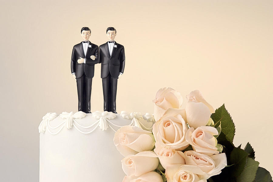 Wedding cake topper and flowers Photograph by Thinkstock Images