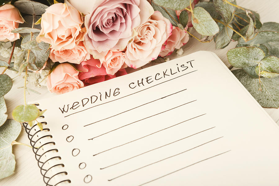 Wedding checklist and rose bouquet Photograph by Prostock-Studio