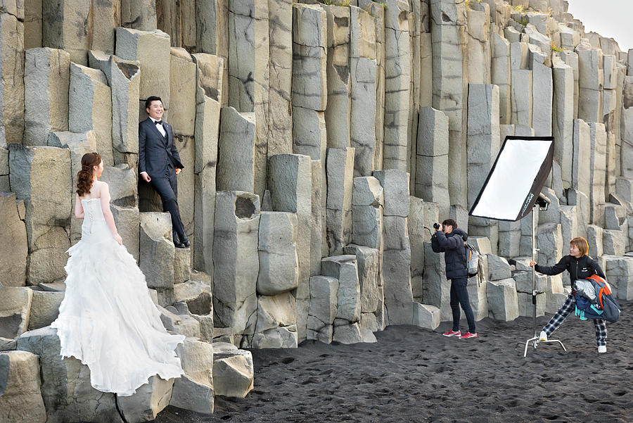 Wedding Photographer working on basalt columns in Reynisfjara beach Photograph by RicardMN Photography