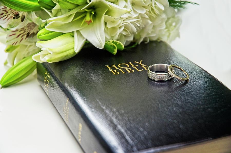 Wedding Rings on Bible with Day Lilies Photograph by Carolyn Marshall