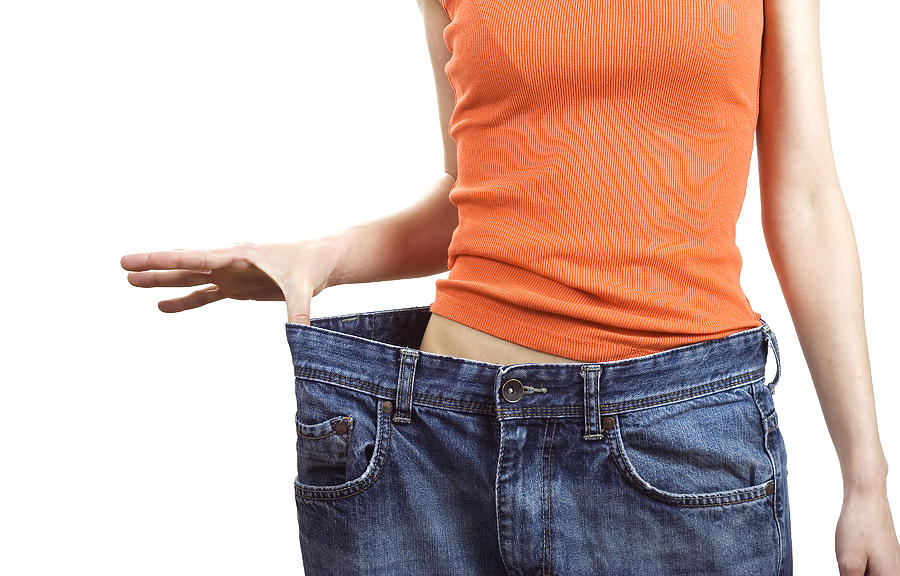 Weight loss concept with woman in bigger size jeans Photograph by Offstocker