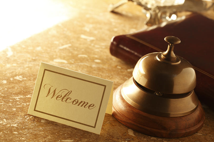 Welcome card and service bell on marble countertop in hotel Photograph by Dny59
