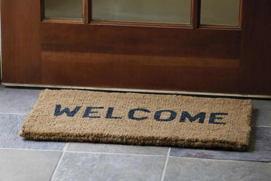 Welcome mat at front door Photograph by Comstock