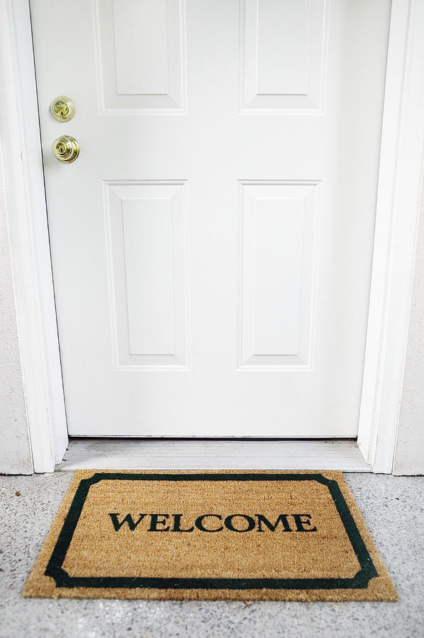 Welcome mat in doorway Photograph by Brand X Pictures