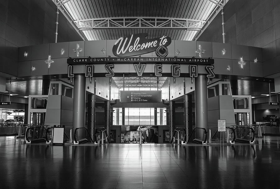 Welcome to Las Vegas Greeting Sign inside an Empty McCarran International Airport Black and White Photograph by Shawn OBrien