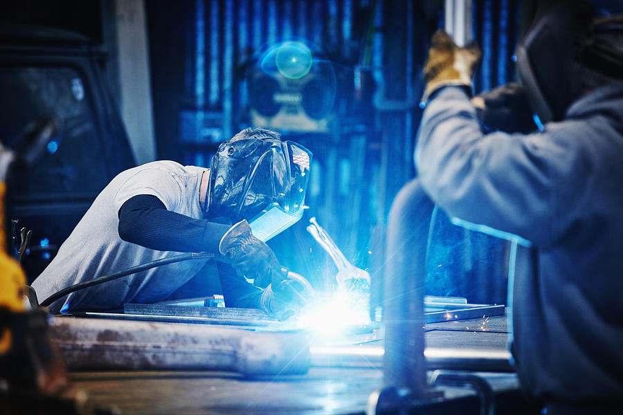 Welder welding frame in metal shop Photograph by Thomas Barwick