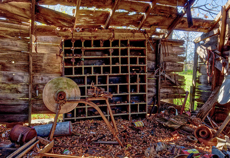 Well-Ventilated Workshop #2 of 2 - vintage grinding stone in an abandoned farm workshop Photograph by Peter Herman
