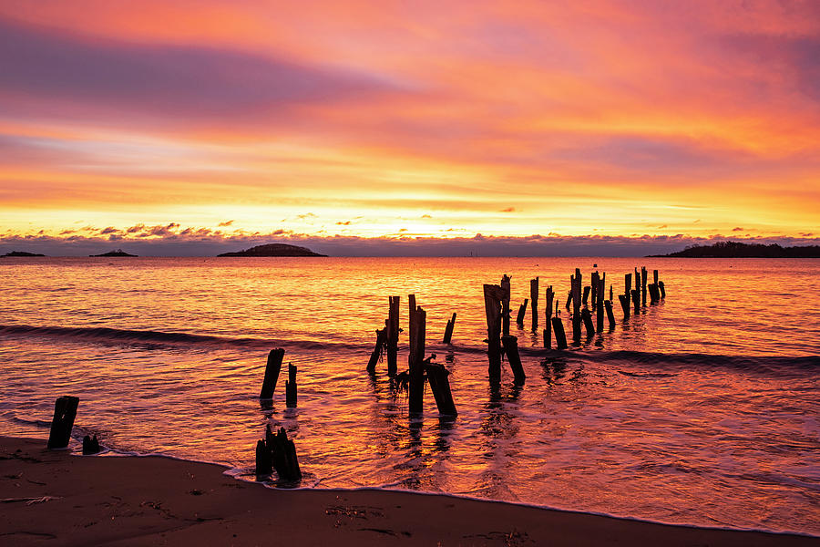 West Beach Vibrant Sunrise over the Pilings Beverly Massachusetts Photograph by Toby McGuire