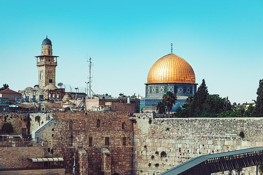 Western Wall with golden Dome of the Rock mosque against blue sky Photograph by Kolderal