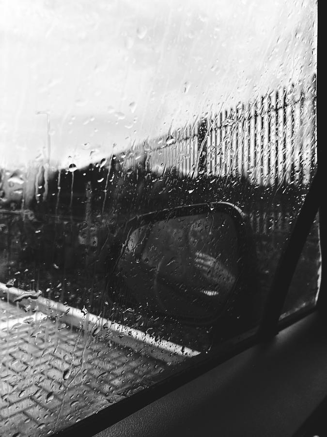 Wet car window and rear viewer covered with raindrops Photograph by ...