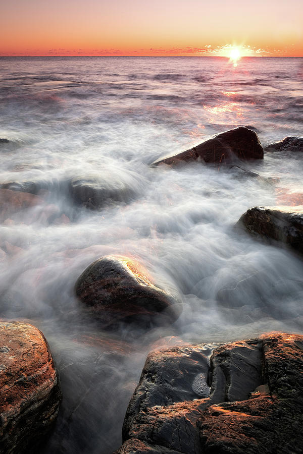 Wet Rocks In The Surf At Sunrise.  Photograph by Jeff Sinon