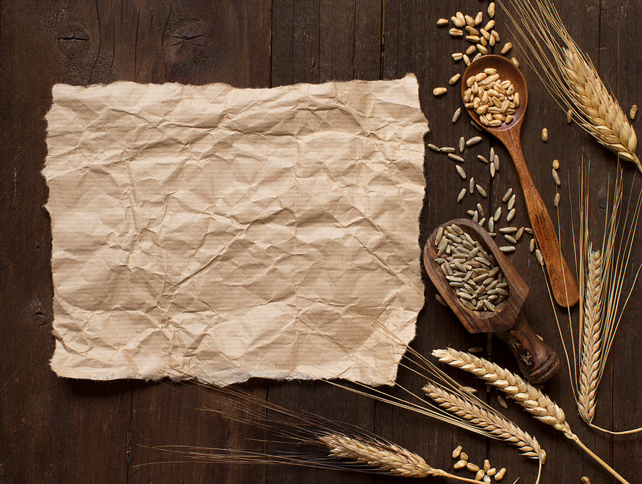 Wheat and spelt on wooden background Photograph by Karisssa