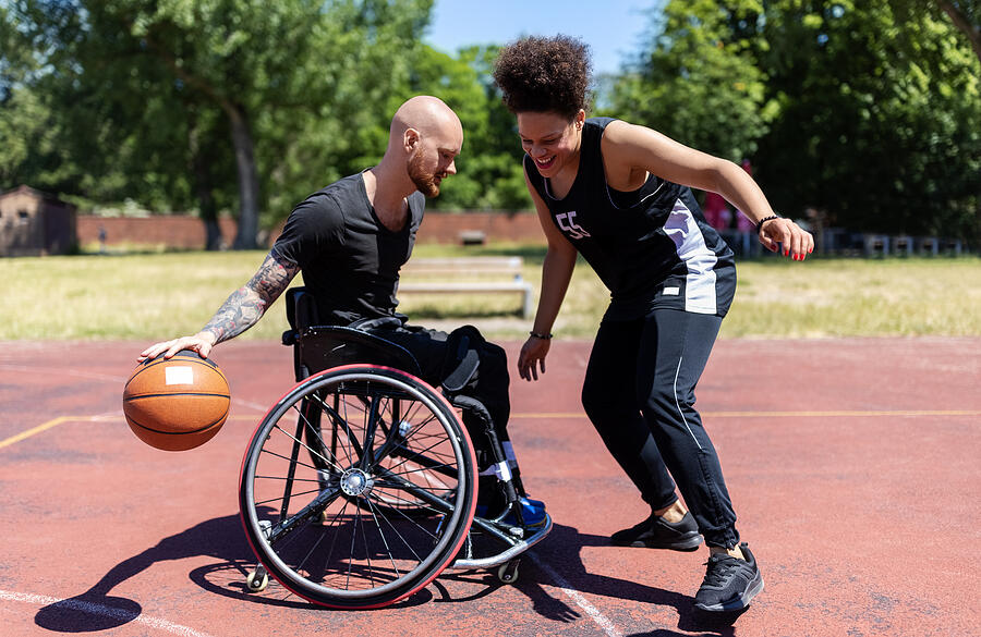 Wheelchair basketball player improving his game skills with coach Photograph by Luis Alvarez