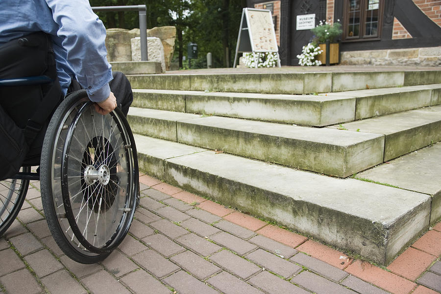Wheelchair user in front of staircase barrier (XXL) Photograph by RelaxFoto.de