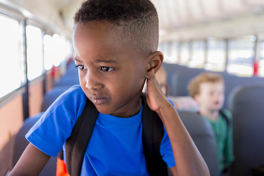 While waiting to get off bus, boy worries about school Photograph by SDI Productions