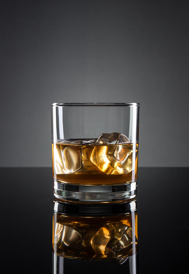 Whisky on gray background Photograph by Belisario Roldan