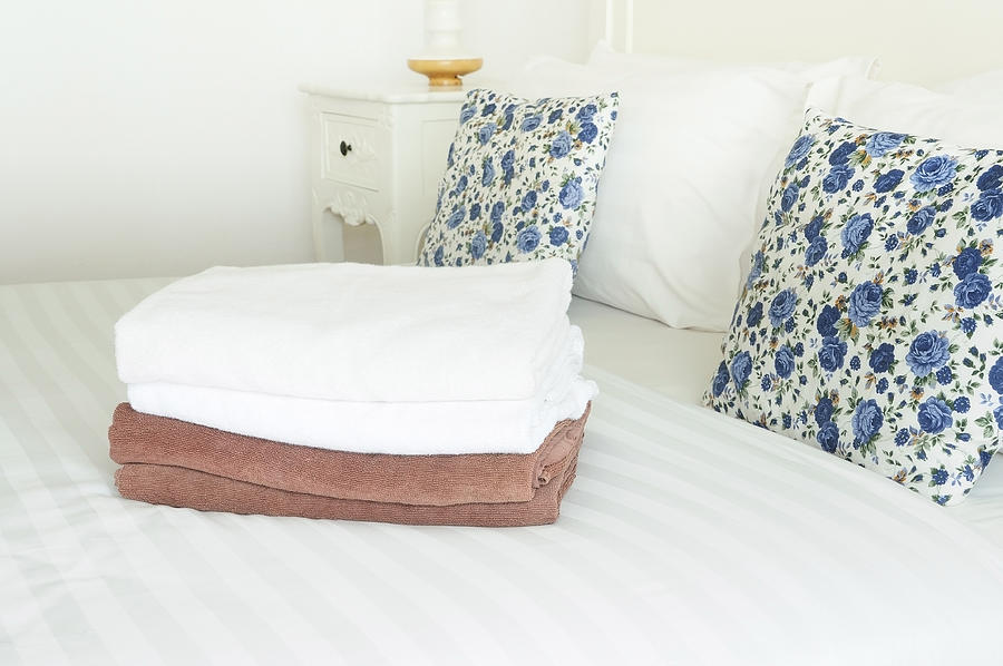 White and brown towels on clean bed with double pillows Photograph by Novaart