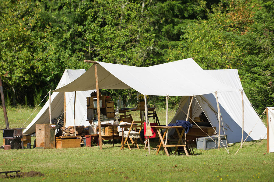 White canvas tents and awning with wood camp furniture Photograph by David L Moore