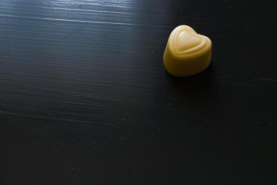 White chocolate heart on dark wooden table Photograph by MichalDziedziak