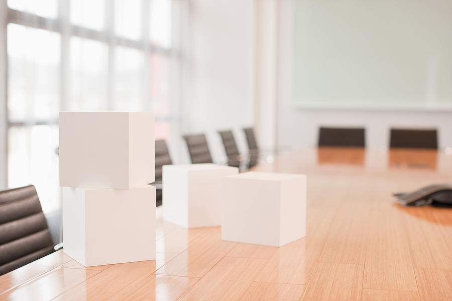White cubes on conference room table Photograph by Martin Barraud