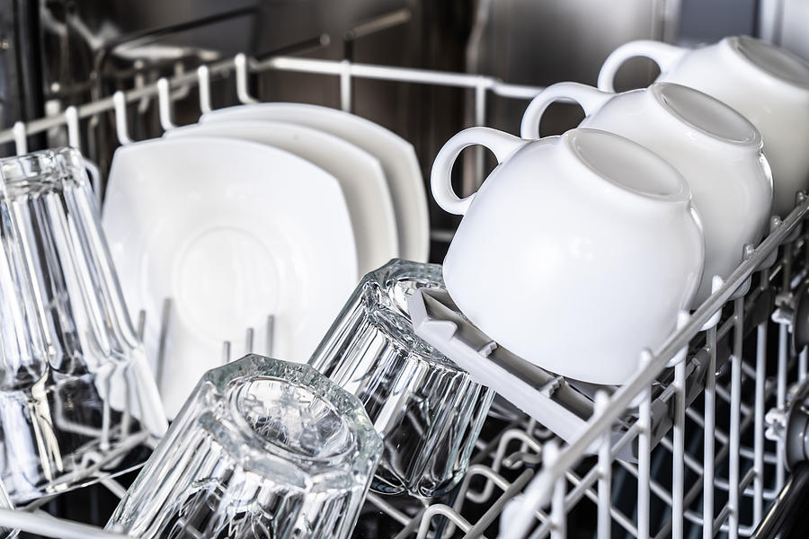 White cups in new dishwasher Photograph by Alex_ugalek