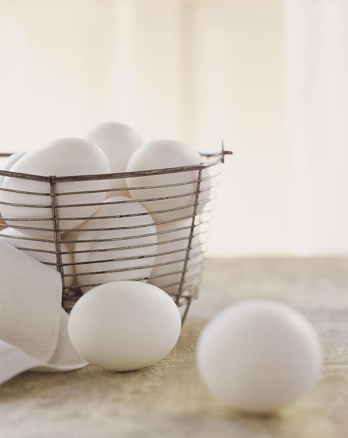 White Eggs in Basket Photograph by Digital Vision.