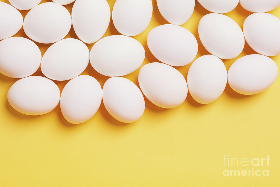 White eggs on yellow background Photograph by Michal Bednarek