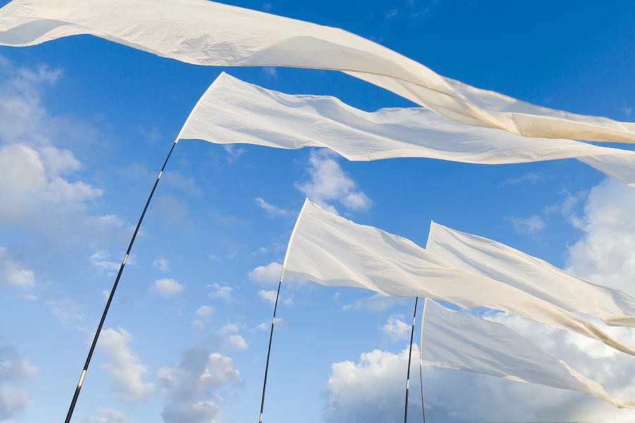 White Flags against blue Sky Photograph by Fentino