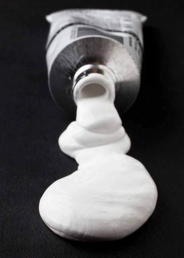 White paint squirting out of tube Photograph by William Andrew