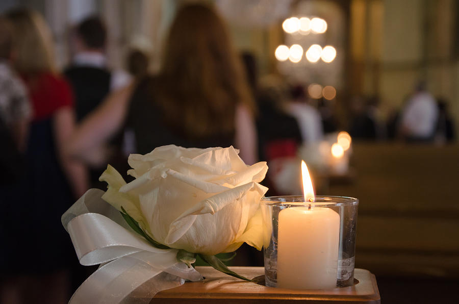 White rose and candle in a church Photograph by Tobias Uhlig