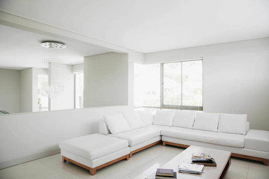 White sofa and mirror in modern living room Photograph by Martin Barraud