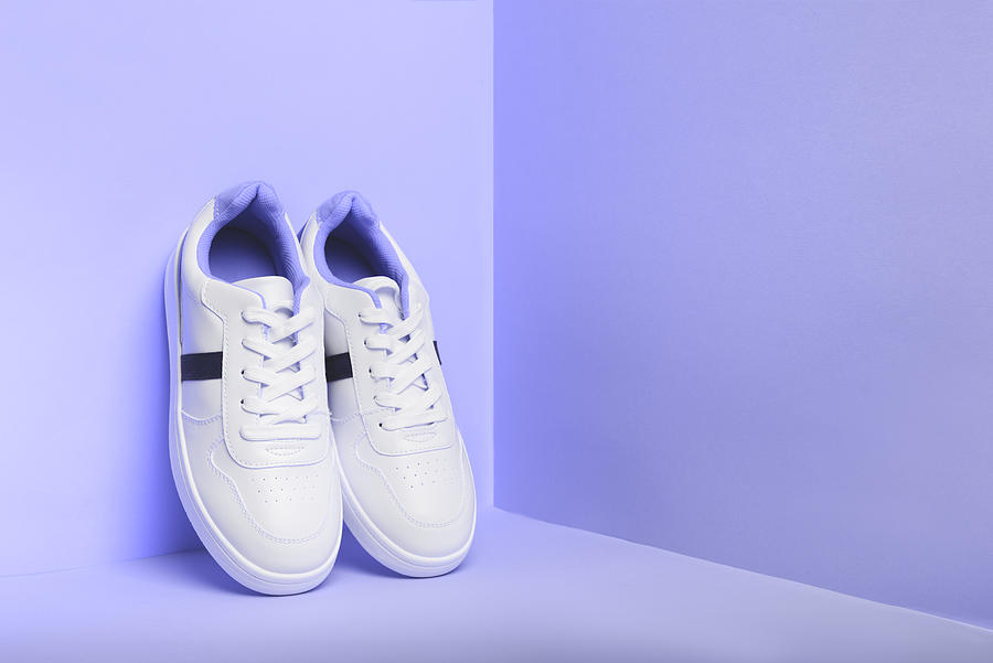 White sport sneakers shoes on the violet background. Fitness background. Photograph by Svetlana  Lavereva
