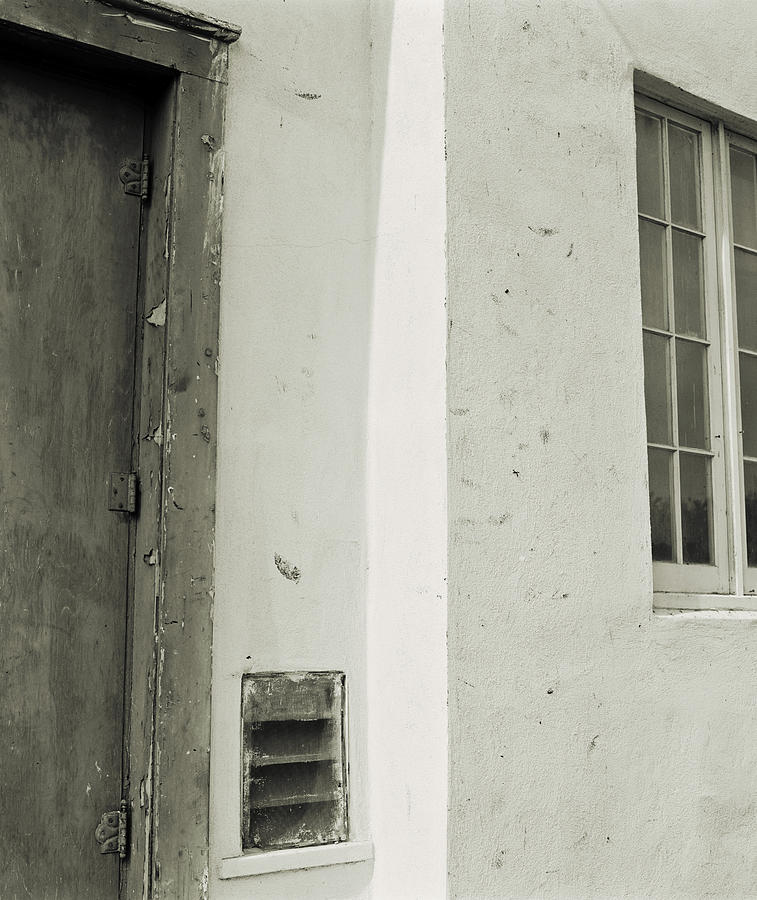 white stucco Mexican mission style wall with window and gray door Photograph by Photodisc