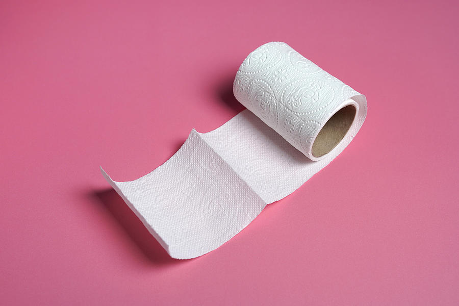 White toilet paper roll with  on pink background Photograph by Eftoefto