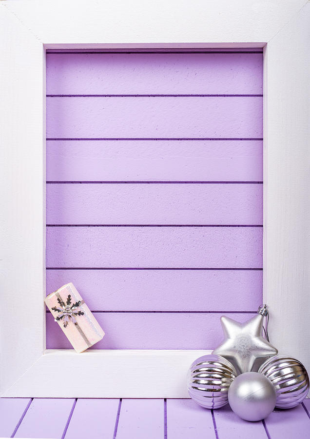 White wooden frame and  christmas decoration over a purple background Photograph by DiyanaDimitrova